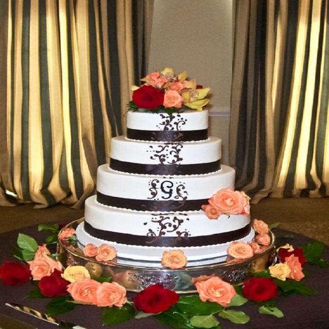 White Cake with Black Design and Flowers
