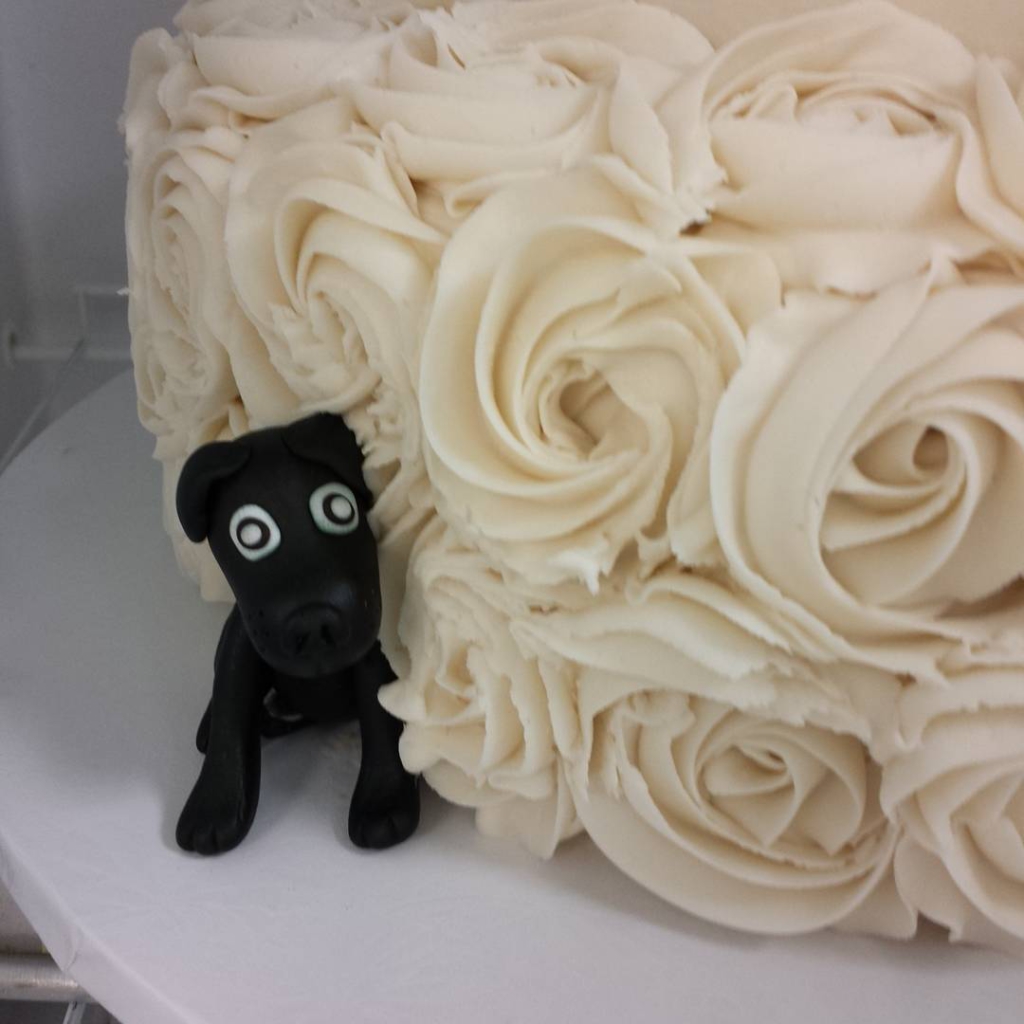 Sneak peek at #weddingwednesday #wedding -sweet fondant lab peeking out from the buttercream roses
